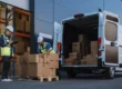 Logistics management workers unload boxes from a van at a warehouse in Salt Lake City, Utah