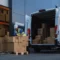 Logistics management workers unload boxes from a van at a warehouse in Salt Lake City, Utah