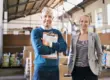 Logistics manager and colleague smiling in a Salt Lake City, Utah warehouse