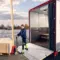 Freight truck with a lowered lift gate and palletized cargo at a delivery location